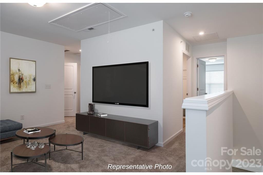 1244 Maple Shade Road Southwest, Unit 73 Concord, NC 28027 - Photo 8 of 12 a living room with furniture and a flat screen tv