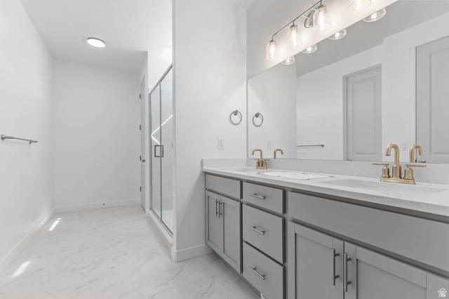 1024 South Tanner Road Santaquin, UT 84655 - Photo 18 of 20 Full bathroom with double vanity, a shower stall, and light marble finish flooring