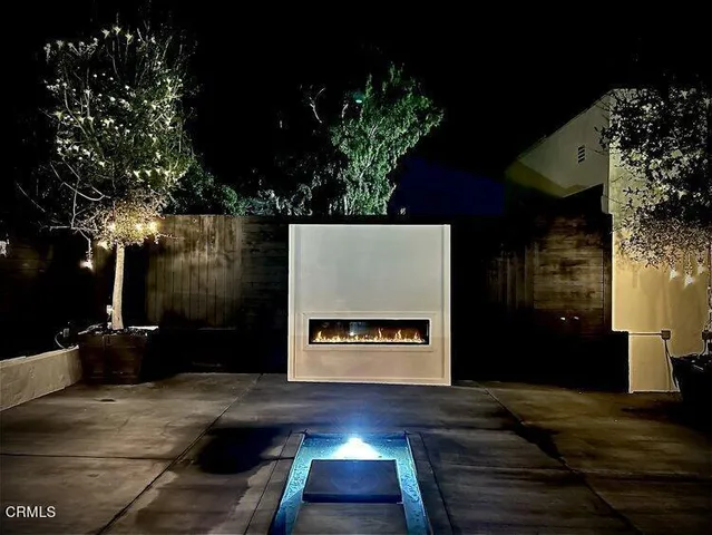 a dining room with lots of furniture and a fireplace