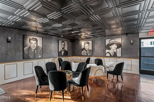 a living room with dining room and wooden floor