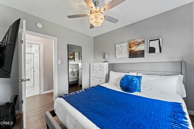 a bedroom with a bed and a chandelier