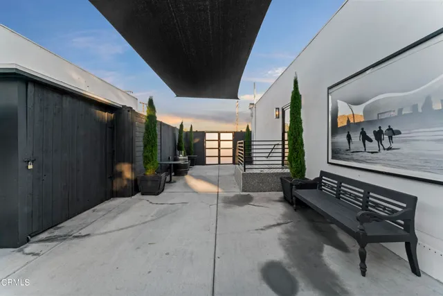 a building outdoor space with patio furniture and potted plants