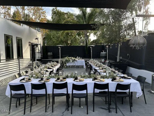 a view of a patio with a dining table and chairs with two couches