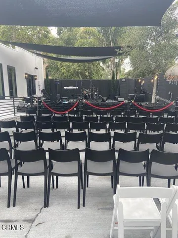 a view of a patio with table and chairs