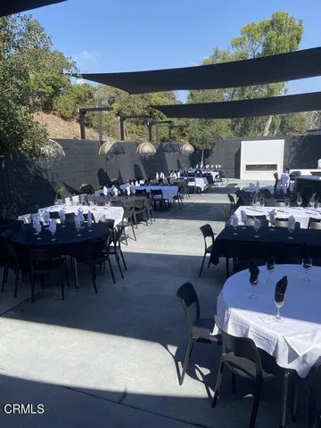 a outdoor dining space with furniture and outdoor view