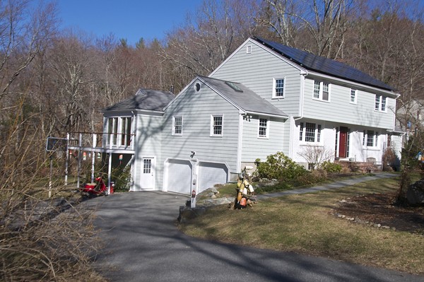 18 Riga Road Dover, MA 02030 - Photo 2 of 24 a view of a house with a yard and garage