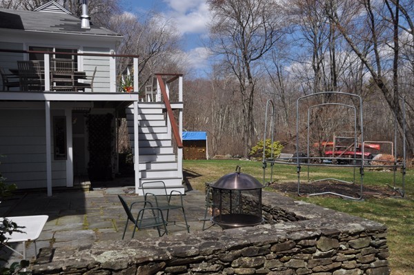 18 Riga Road Dover, MA 02030 - Photo 21 of 24 a backyard of a house with barbeque oven table and chairs