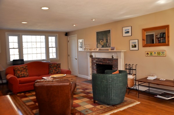18 Riga Road Dover, MA 02030 - Photo 10 of 24 a living room with furniture a flat screen tv and a fireplace