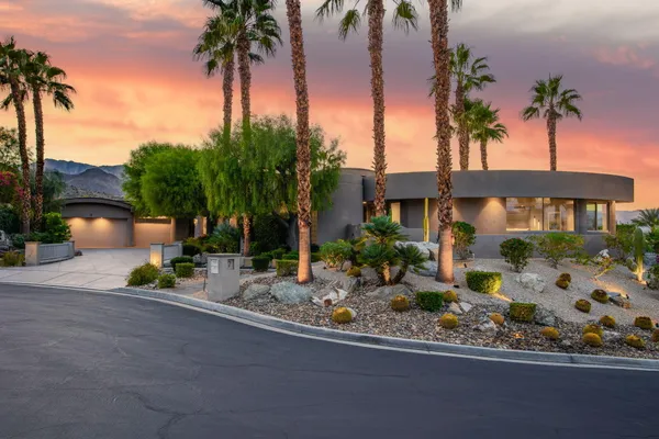 a view of a house with swimming pool next to a yard