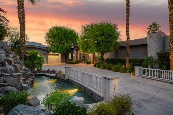 a view of a house with swimming pool and sitting area