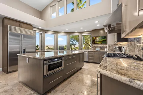 a view of a hallway with wooden floor and cabinet