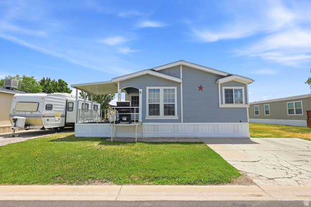 2491 Highway 89, Unit 614 Pleasant View, UT 84404 - Photo 3 of 27 Single-story residence featuring light blue siding with white trim accents