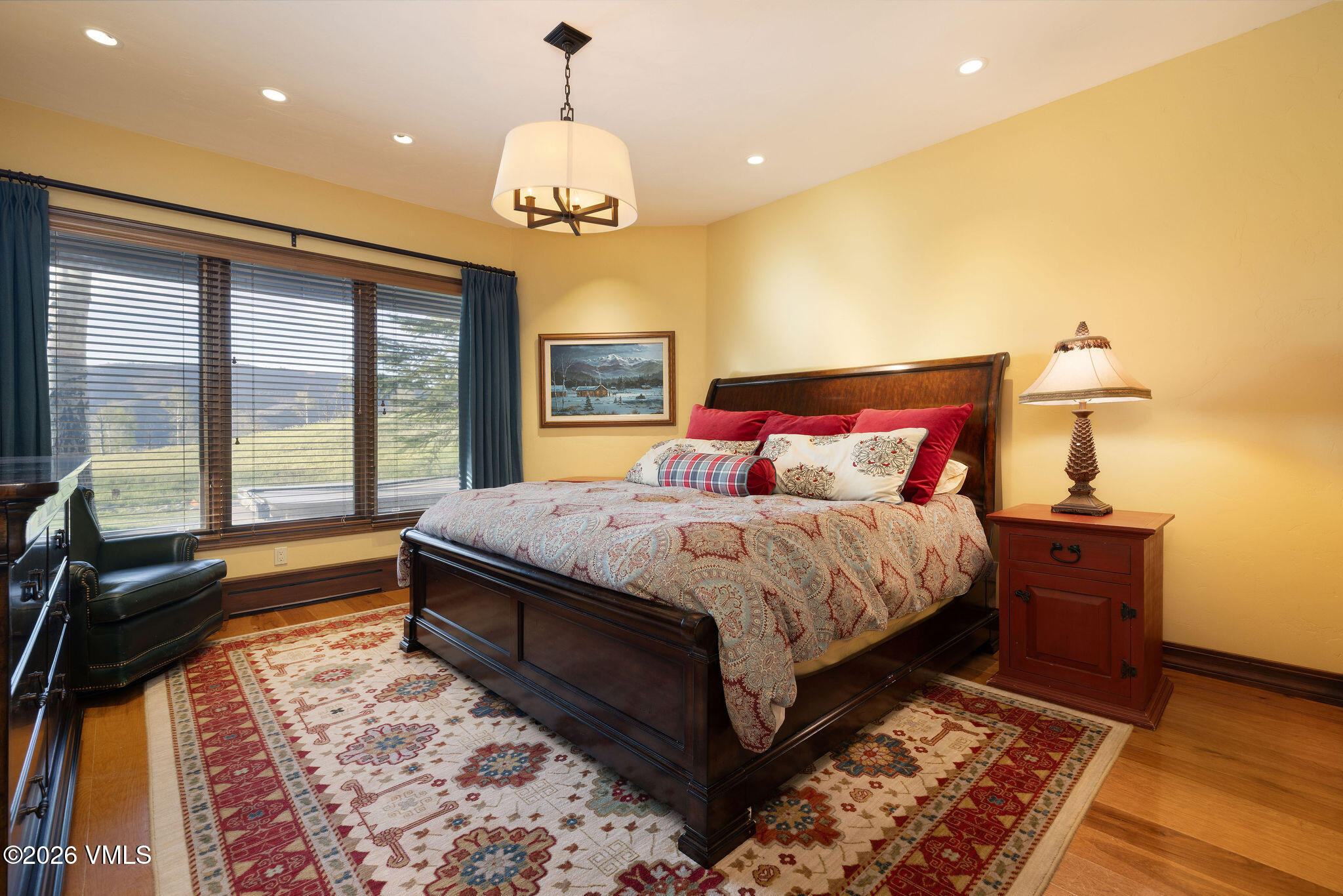 102 Saddle Ridge Loop Edwards, CO 81632 - Photo 14 of 29 a spacious bedroom with a bed and a chandelier