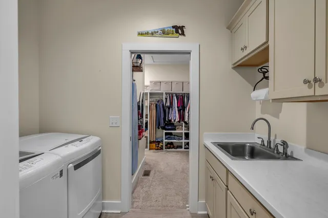 a utility room with sink dryer and washer