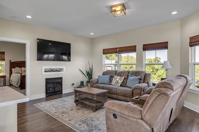a living room with fireplace furniture and a flat screen tv