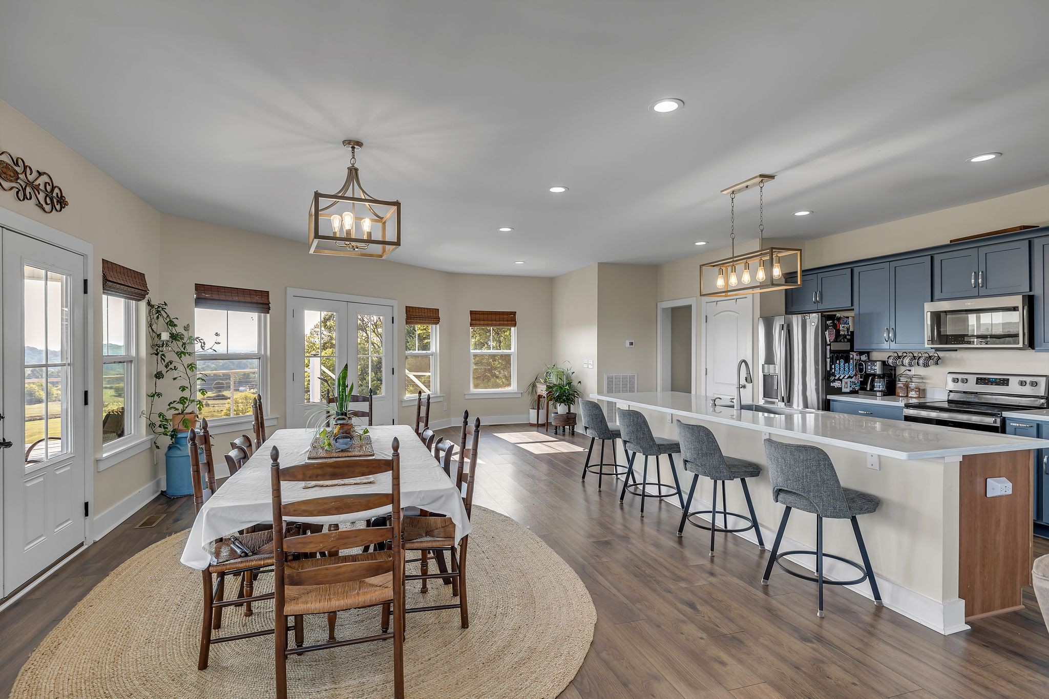 2770 East Sheepneck Road Culleoka, TN 38451 - Photo 5 of 49 a view of a dining room with furniture large windows and wooden floor