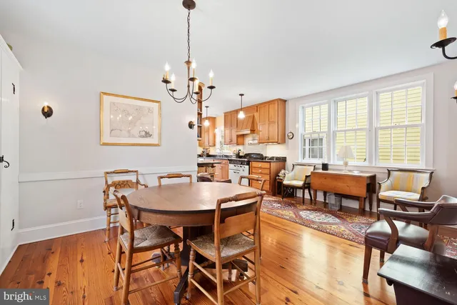 a view of a room with wooden floor and windows