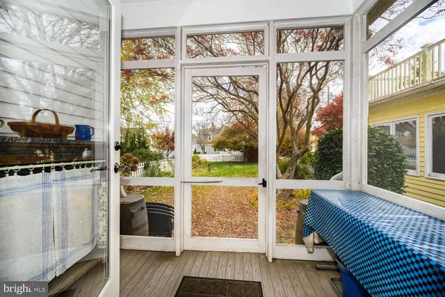 a view of a hallway with entryway wooden floor and front door