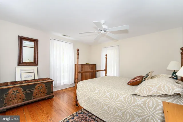 a bedroom with a bed and a painting