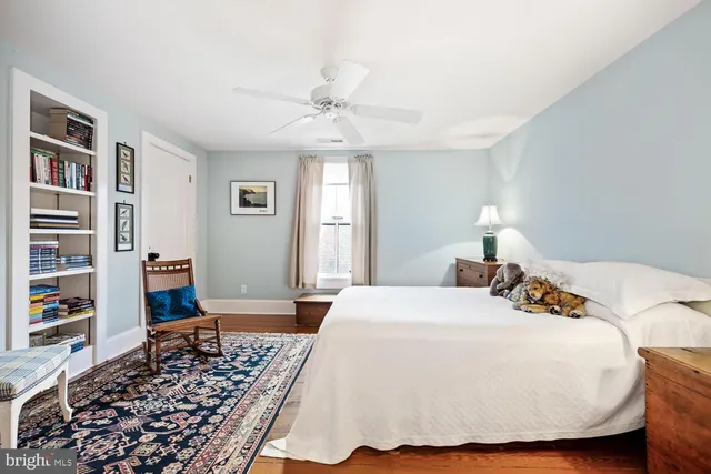 a spacious bathroom with a granite countertop double vanity sink a mirror a bathtub and shower