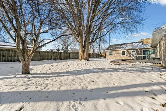 a view of a house with a yard covered in snow