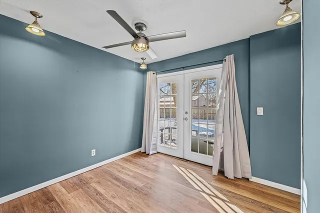 wooden floor in an empty room with a window