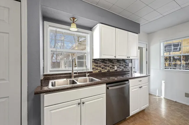 a kitchen with granite countertop a stove and a sink