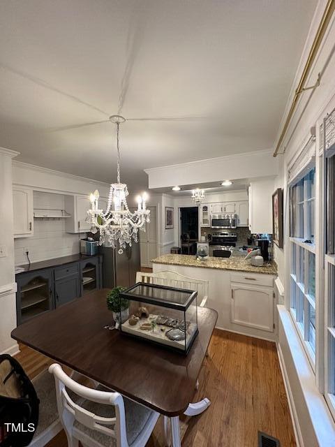 1905 Topsfield Court Raleigh, NC 27615 - Photo 30 of 45 a kitchen with sink refrigerator and dining table