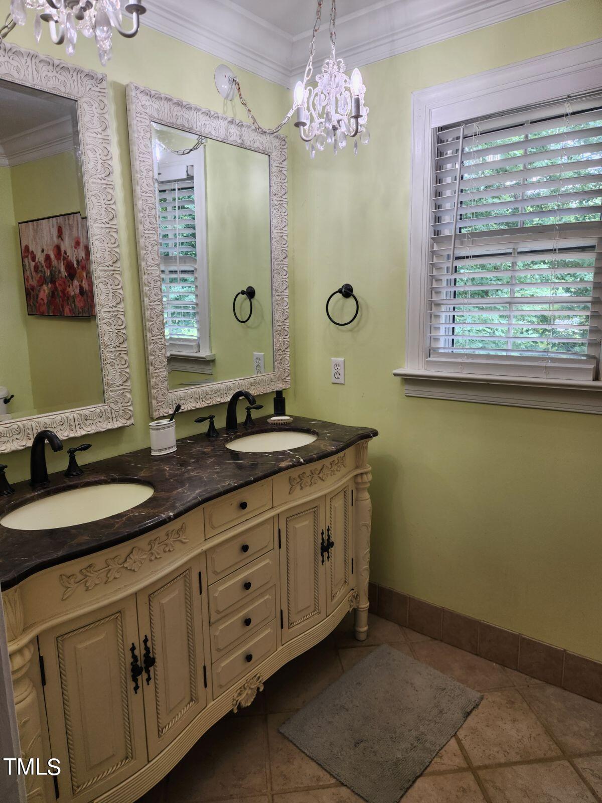 1905 Topsfield Court Raleigh, NC 27615 - Photo 40 of 45 a bath room with a mirror and a sink