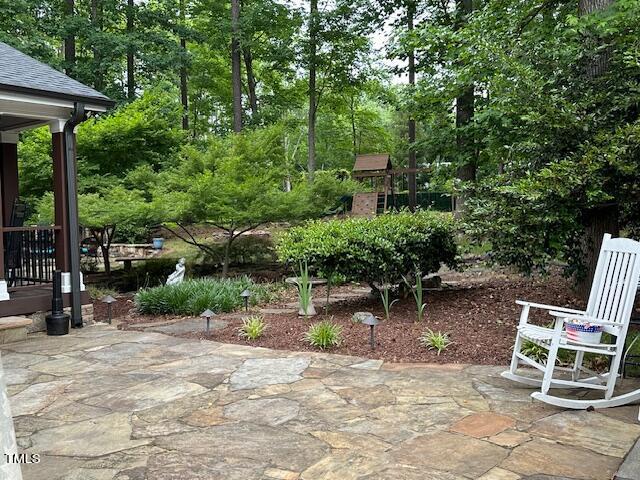 1905 Topsfield Court Raleigh, NC 27615 - Photo 8 of 45 a view of backyard with a table and chairs under an umbrella
