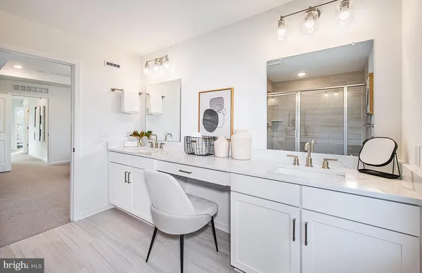 a bathroom with a granite countertop sink a toilet and a mirror