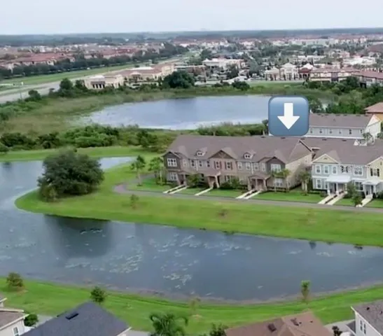an aerial view of a house with yard and outdoor seating