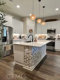 a kitchen with stainless steel appliances granite countertop a stove a sink a refrigerator and a granite counter tops