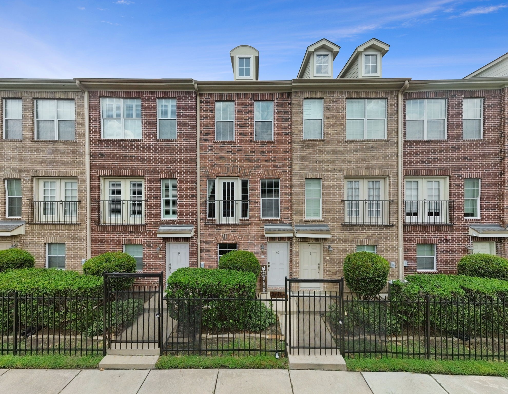 1913 Gillette Street, Unit C Houston, TX 77006 - Photo 1 of 23 a front view of a house with a garden