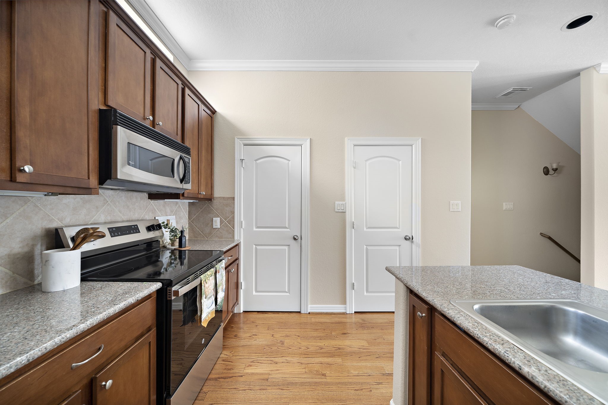 1913 Gillette Street, Unit C Houston, TX 77006 - Photo 4 of 23 a kitchen with stainless steel appliances granite countertop a sink stove and refrigerator