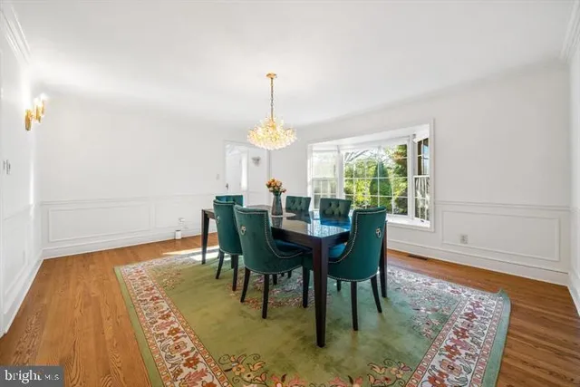 a living room with stainless steel appliances granite countertop a kitchen island hardwood floor and a view of kitchen