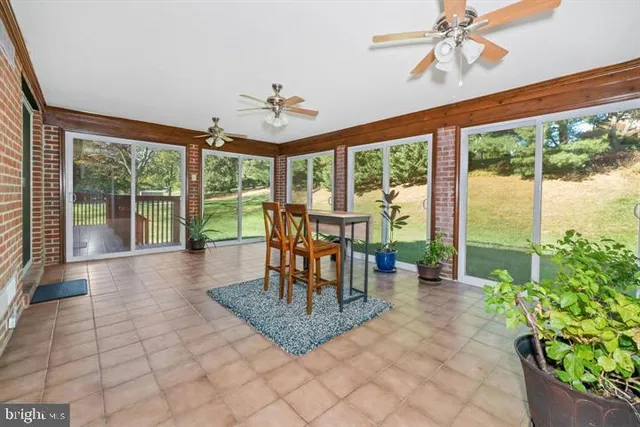 a work room with furniture a rug and a window