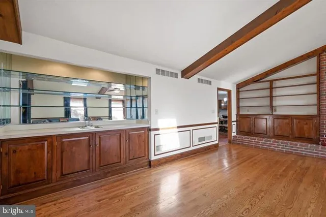 a living room with furniture a ceiling fan and a large window