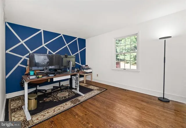 a bathroom with a granite countertop sink a large mirror a and window