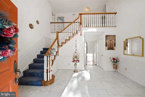 a dining room with wooden floor and a rug