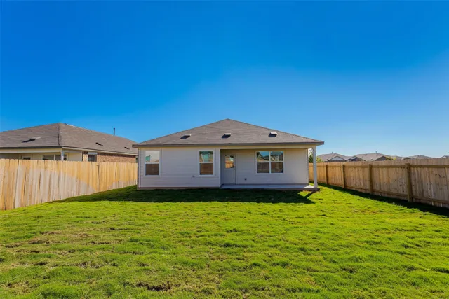 a view of a backyard of the house