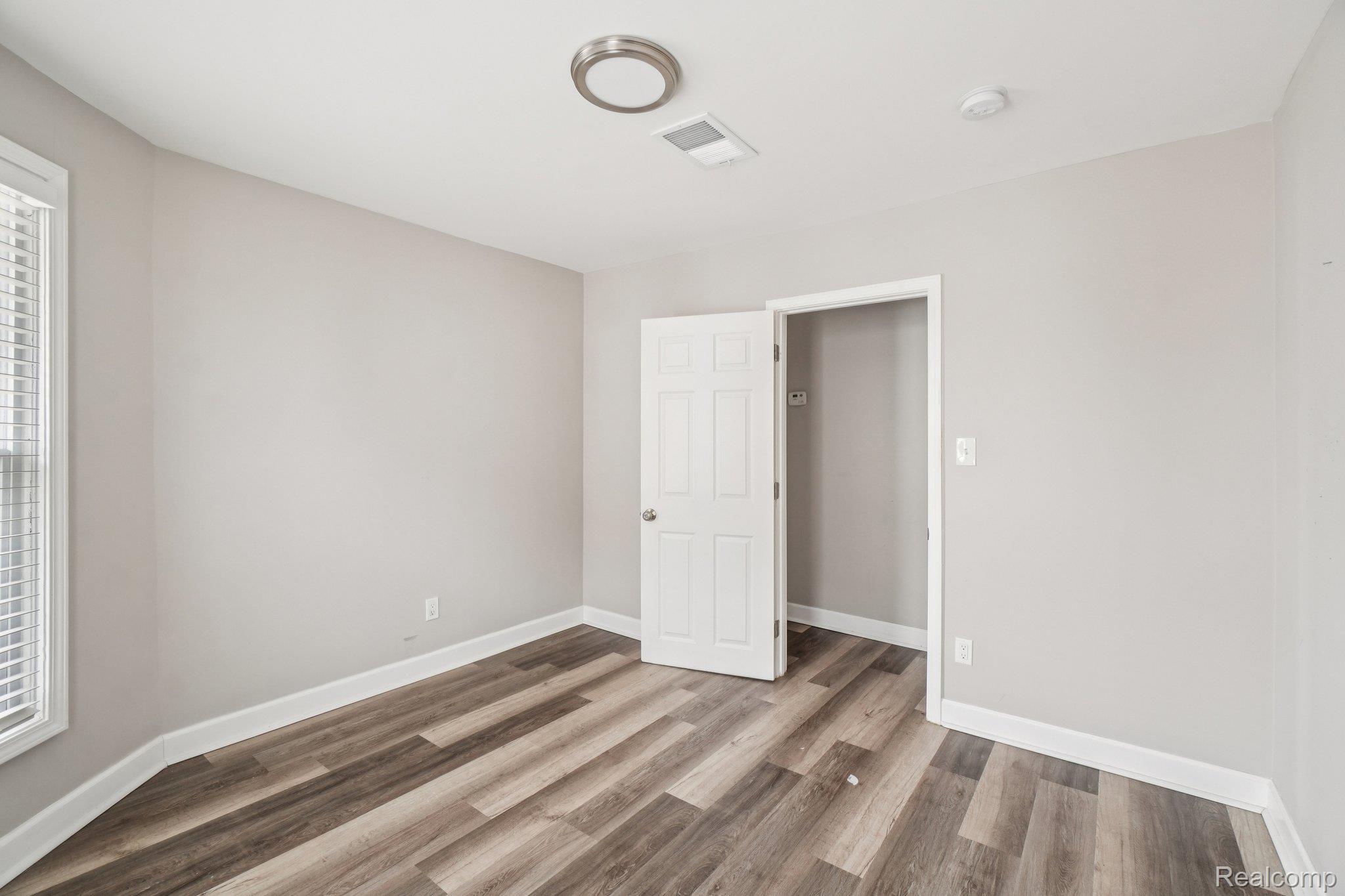 3822 Wabash Street Detroit, MI 48208 - Photo 15 of 17 Unfurnished bedroom with light wood-style floors and baseboards