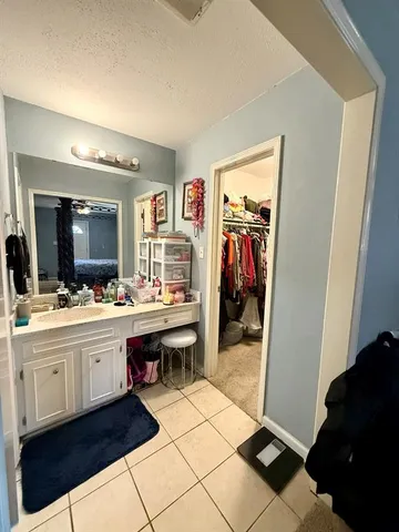 a large bathroom with a double vanity sink and a mirror