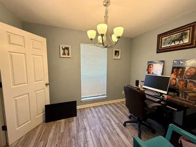 a view of a workspace with furniture and wooden floor