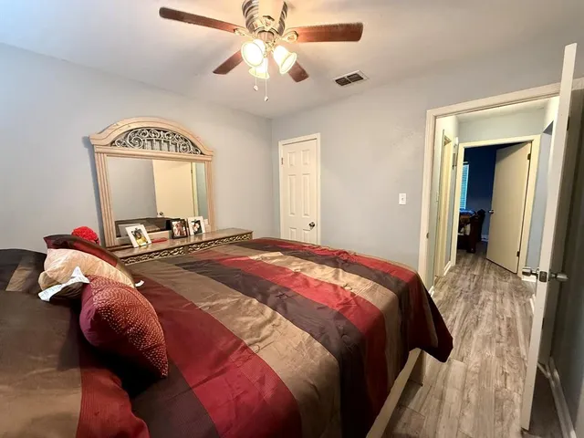 a bedroom with a bed and a chandelier
