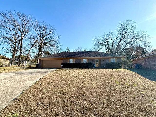 a large house with a tree in the background