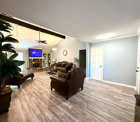 a living room with furniture window and a wooden floor