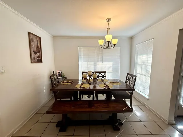a view of a dining room with furniture and chandelier