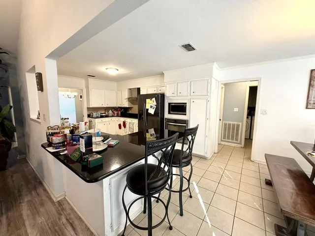 a kitchen with stainless steel appliances kitchen island granite countertop a sink and cabinets