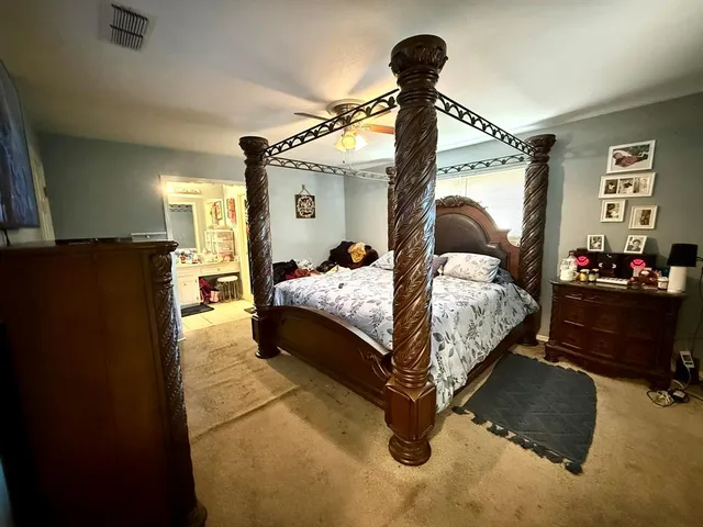 a bedroom with a bed and a mirror
